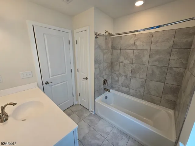 a bathroom with a bathtub and a sink