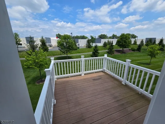 a view of balcony with wooden floor and fence