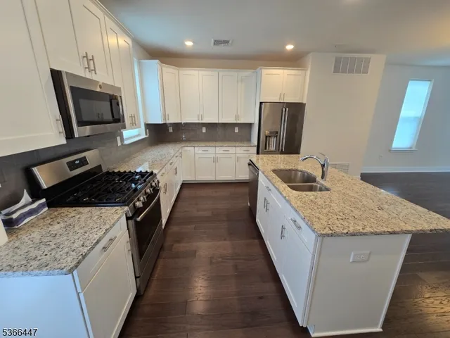 a large kitchen with a stove and a sink