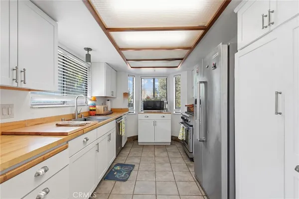 a kitchen with a sink cabinets and window