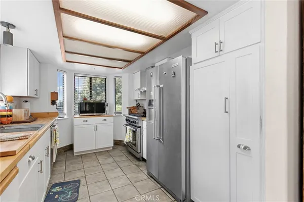 a kitchen with white cabinets and white appliances
