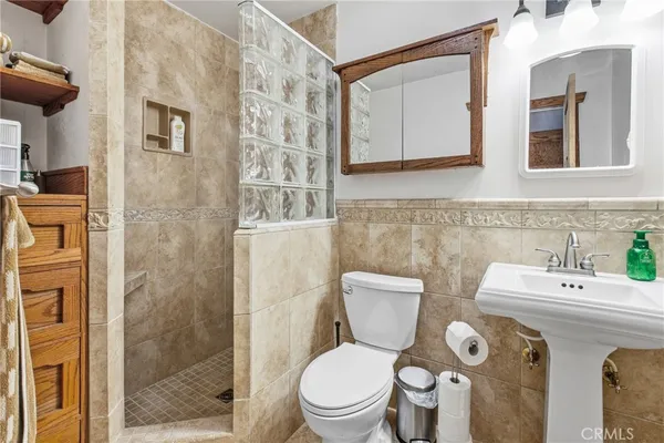 a bathroom with a toilet sink and shower