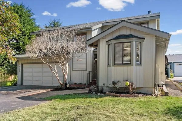a front view of a house with garden
