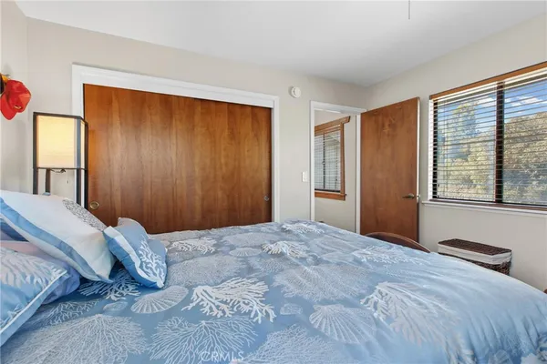 a bedroom with a large bed and a large window