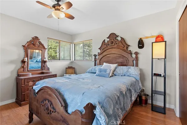 a bedroom with a bed and wooden floor