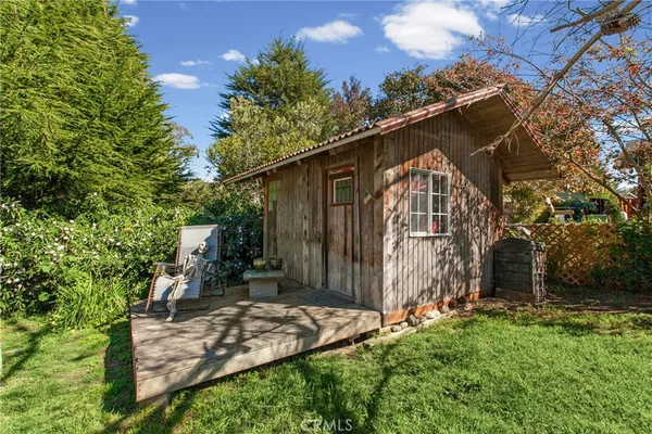 a front view of house with a garden and patio