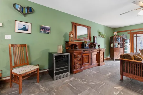 a living room with furniture a piano and a flat screen tv