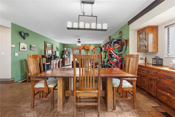 a view of a dining room with furniture wooden floor and chandelier