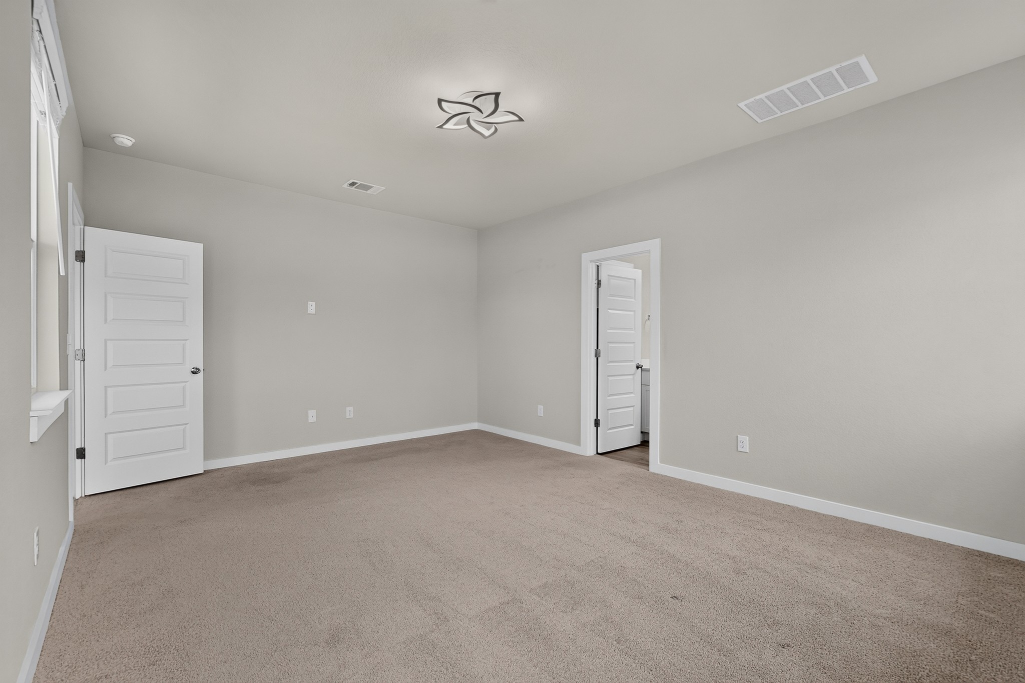 116 Appleberry Lane Elgin, TX 78621 - Photo 15 of 35 A spacious, neutral-toned room offers a tranquil setting with ample natural light.