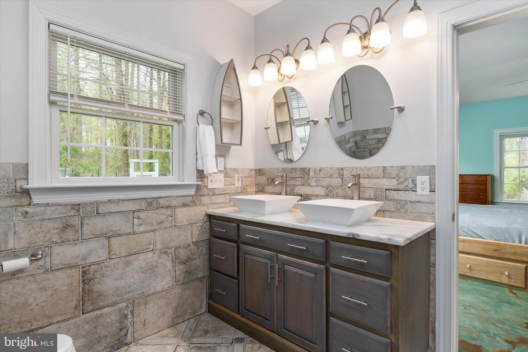 730 Central Avenue East Edgewater, MD 21037 - Photo 22 of 63 a bathroom with a sink and a mirror
