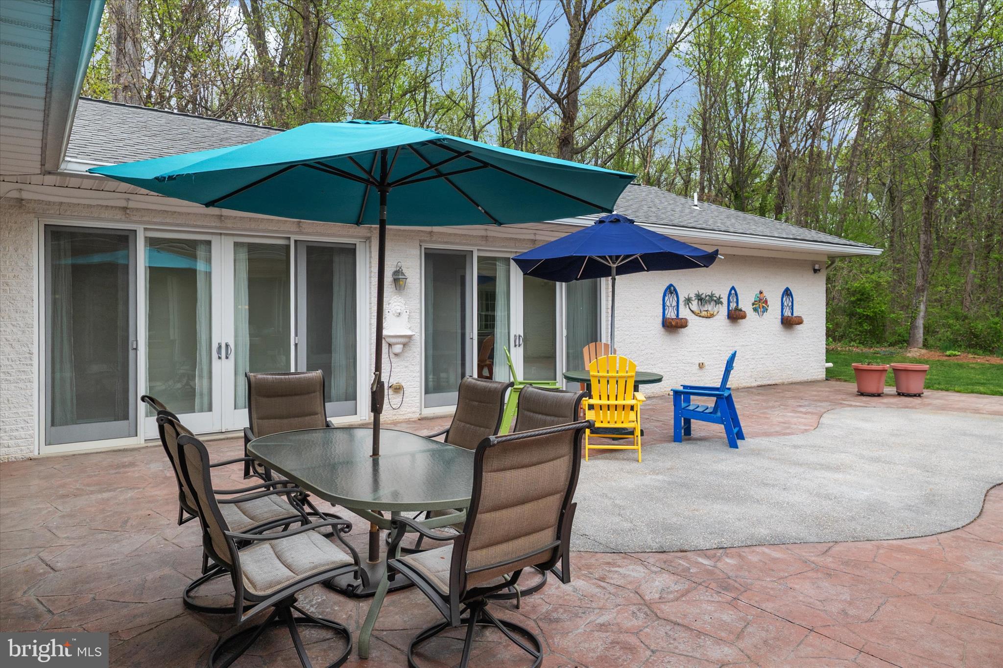 730 Central Avenue East Edgewater, MD 21037 - Photo 37 of 63 a view of a patio with table and chairs under an umbrella