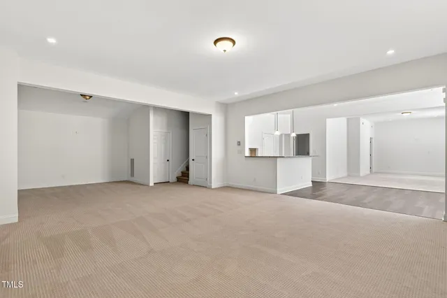 a view of kitchen with stainless steel appliances granite countertop a refrigerator and a sink