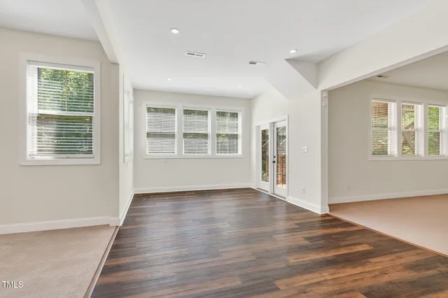 a view of a hallway with wooden floor and closet