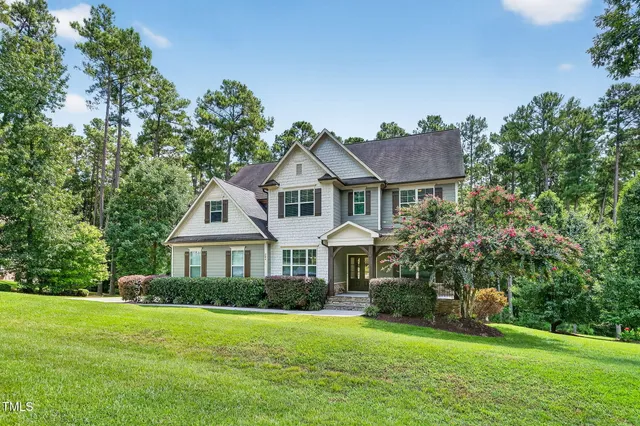 a view of empty room with a kitchen and refrigerator