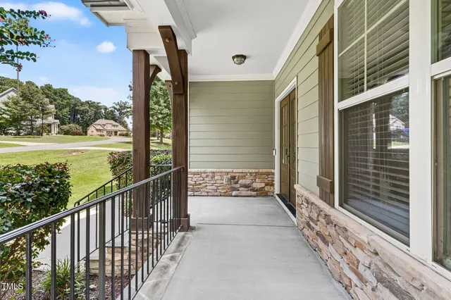 a view of a room with wooden floor and windows