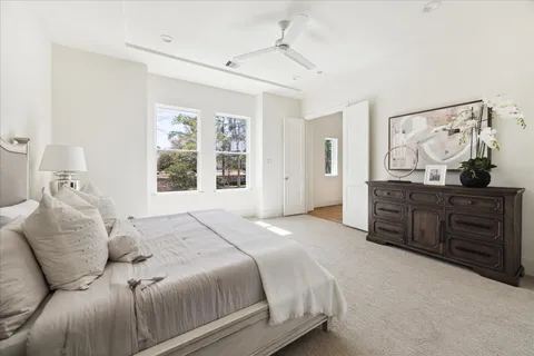 a bedroom with a bed and a chandelier
