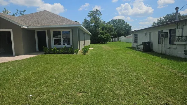 a view of a house with a yard and a garden