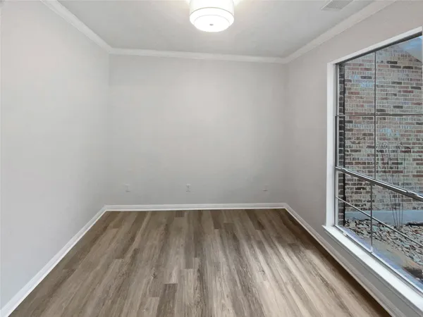 a view of a room with wooden floor and small racks