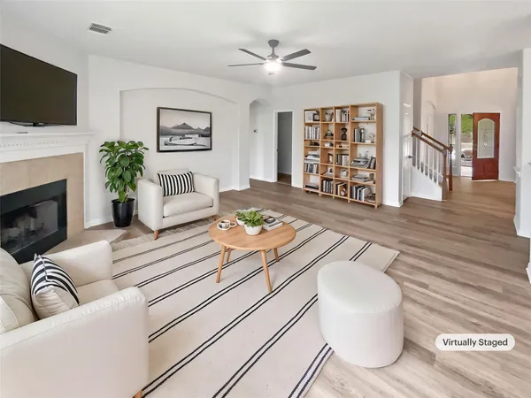 a living room with furniture fireplace and flat screen tv