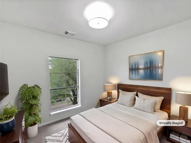 a bedroom with bed and a window