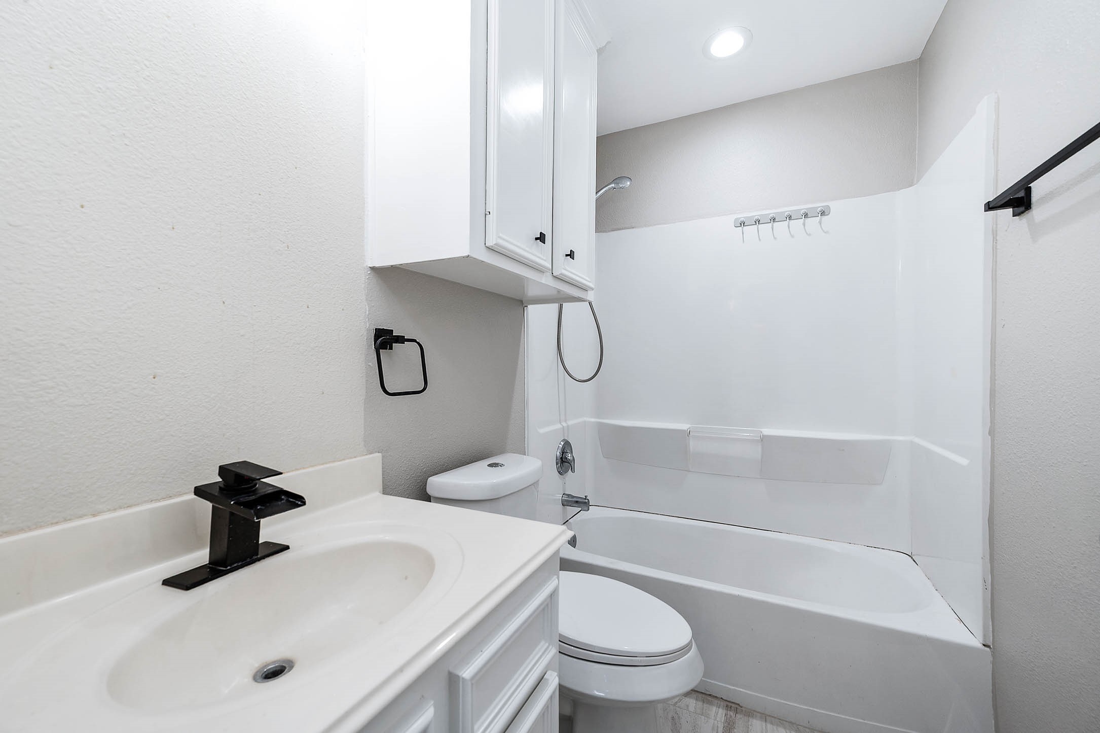 7308 Avenue R Galveston, TX 77551 - Photo 16 of 24 a bathroom with a sink toilet and shower