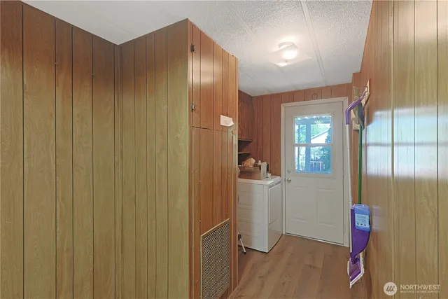 an empty room with windows and wooden floor