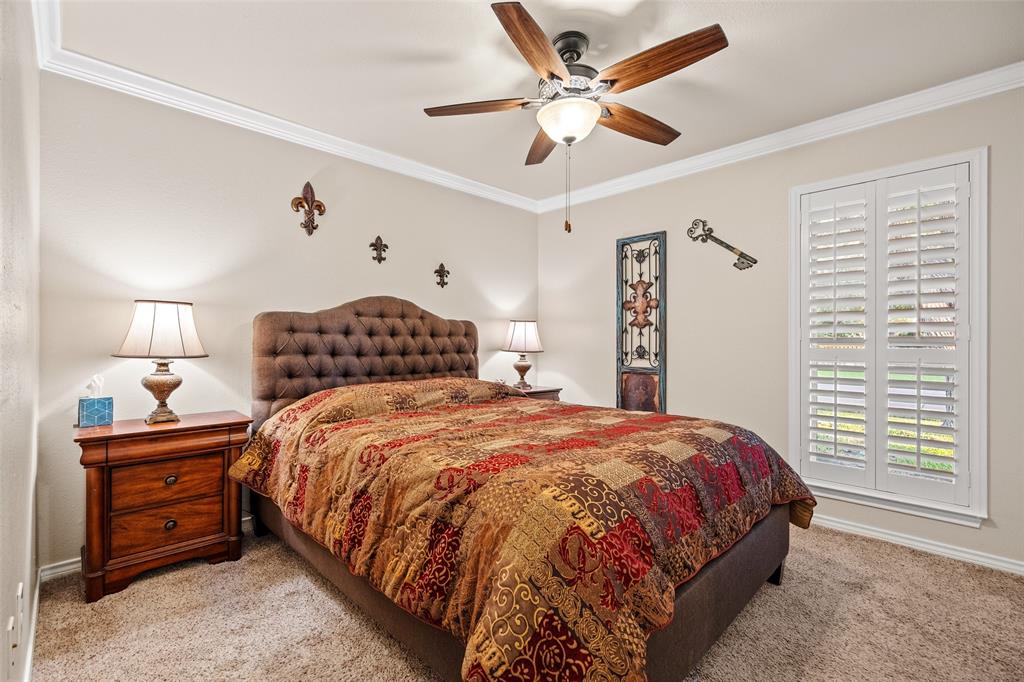 400 Hunters Ridge Circle Coppell, TX 75019 - Photo 14 of 35 a bedroom with a bed and a chandelier