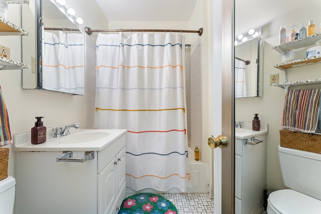 1408 Commonwealth Avenue, Unit 14 Boston, MA 02135 - Photo 11 of 12 a bathroom with a sink toilet and shower