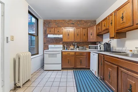 a kitchen with a stove top oven sink and cabinets