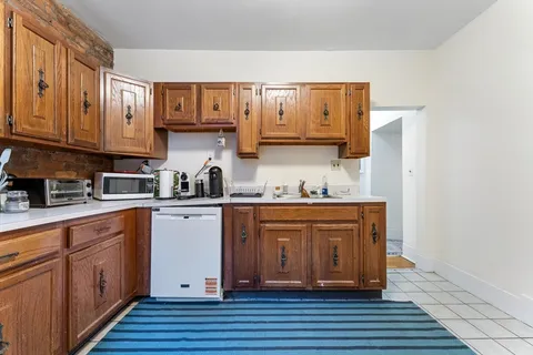 a kitchen with stainless steel appliances granite countertop a sink and cabinets