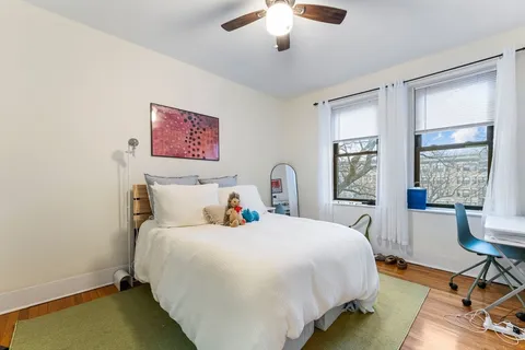a bedroom with a bed a table and chair