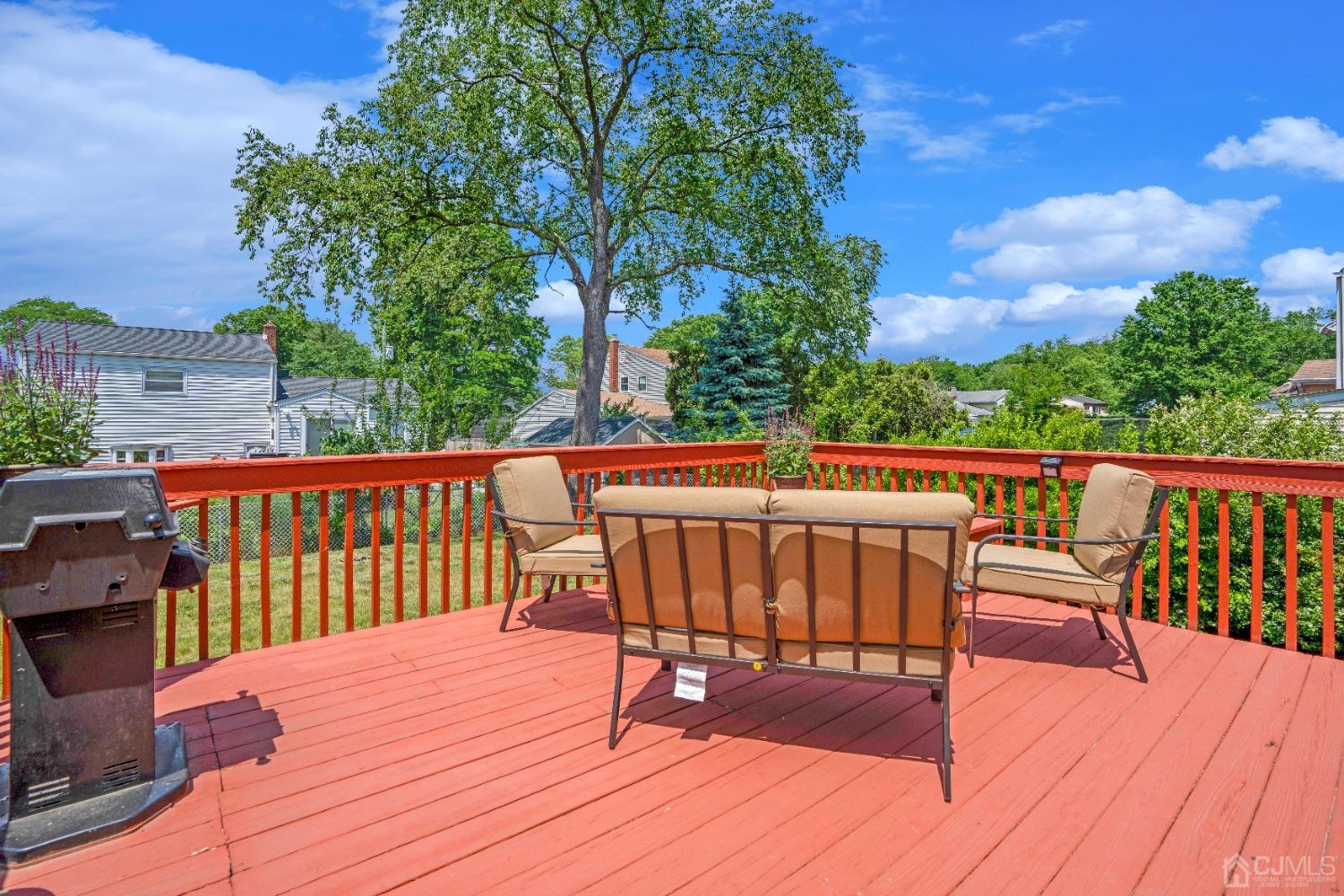 15 Brian Road Edison, NJ 08817 - Photo 17 of 19 a view of deck with a table and chairs with wooden floor and fence