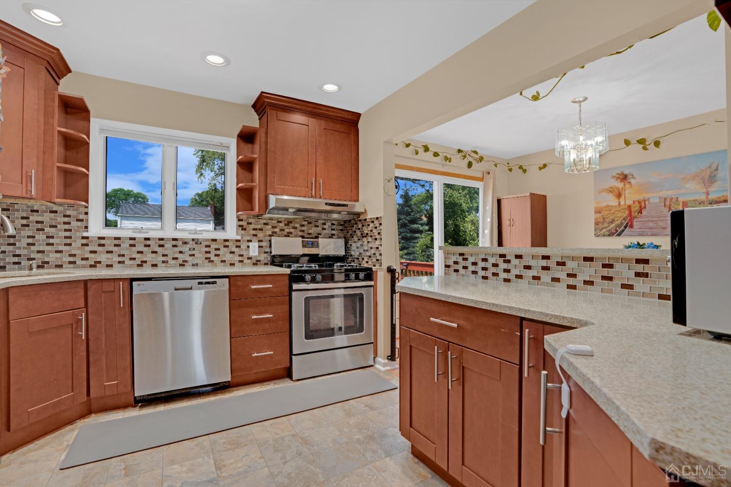 15 Brian Road Edison, NJ 08817 - Photo 6 of 19 a kitchen with stainless steel appliances granite countertop a stove a sink dishwasher and a refrigerator with wooden cabinets