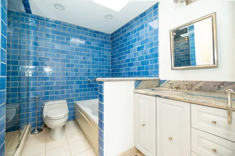 a bathroom with a white bath tub a toilet and a sink