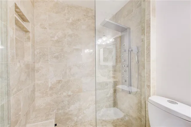 a bathroom with a sink vanity granite and toilet