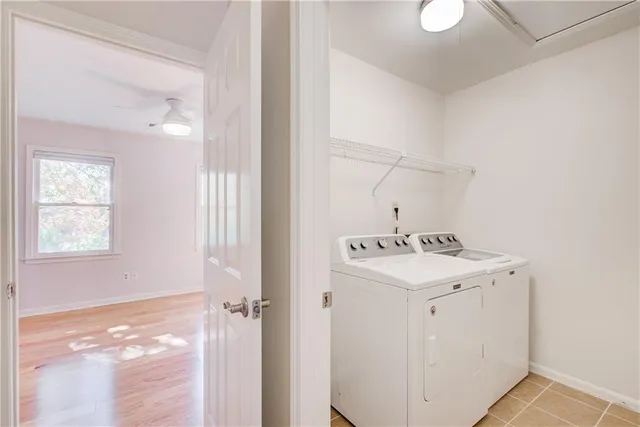 a bedroom with a large bed and a potted plant