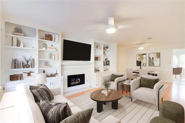 a living room with furniture a fireplace and a flat screen tv
