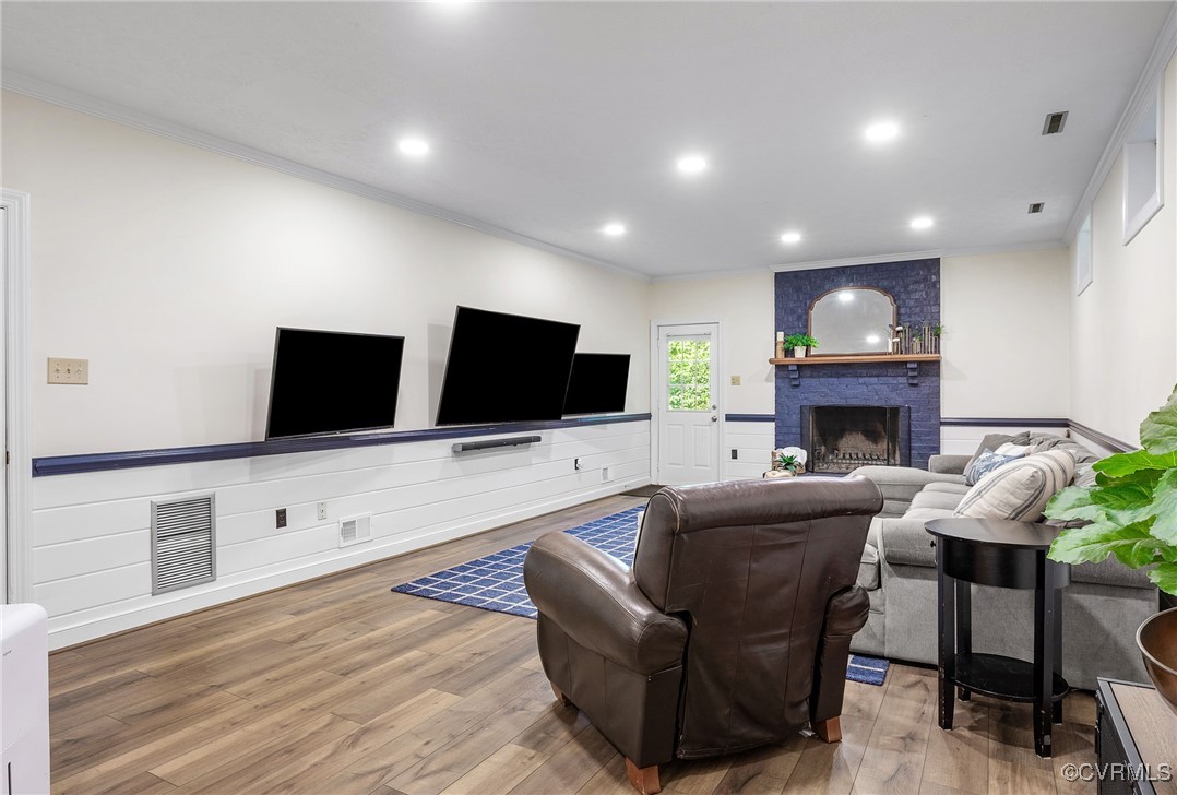 14471 West Salisbury Road Midlothian, VA 23113 - Photo 39 of 46 a living room with furniture a flat screen tv and a fireplace