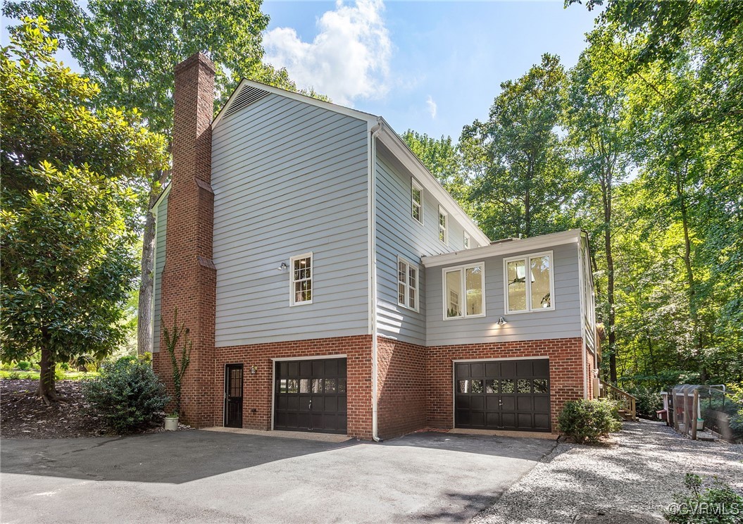 14471 West Salisbury Road Midlothian, VA 23113 - Photo 43 of 46 a front view of a house with a yard and garage
