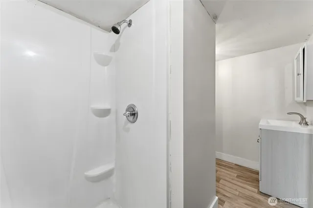 a bathroom with a toilet and a shower