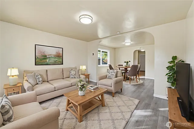 a living room with furniture a flat screen tv and a fireplace