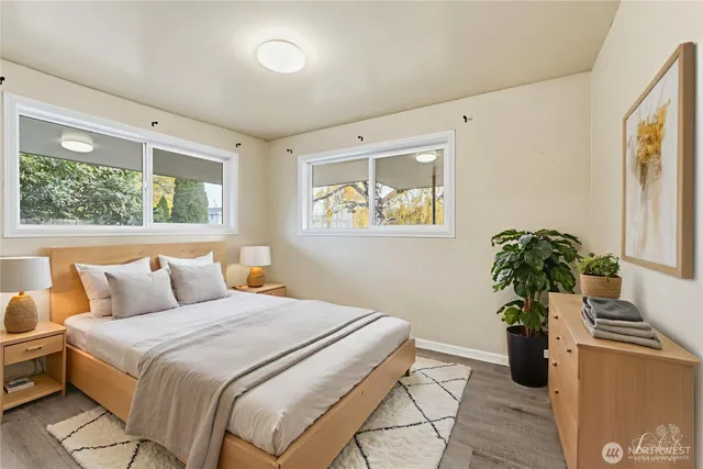 a bedroom with a bed and a potted plant