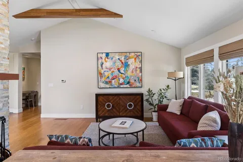 a living room with furniture a rug and a window