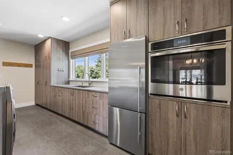 a kitchen with stainless steel appliances granite countertop a refrigerator and a sink