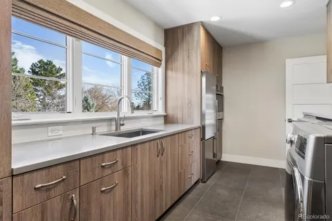 a kitchen with a sink and a large window