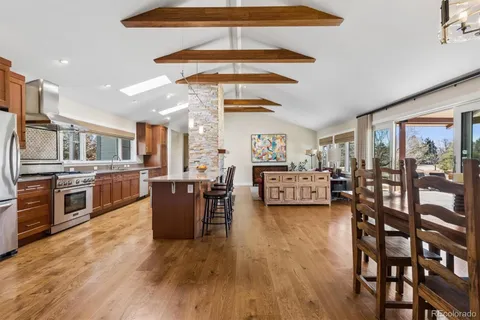 a living room with furniture and a kitchen