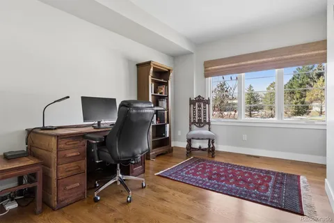 a view of a workspace with furniture and a window