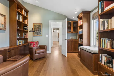 a living room with furniture and a book shelf
