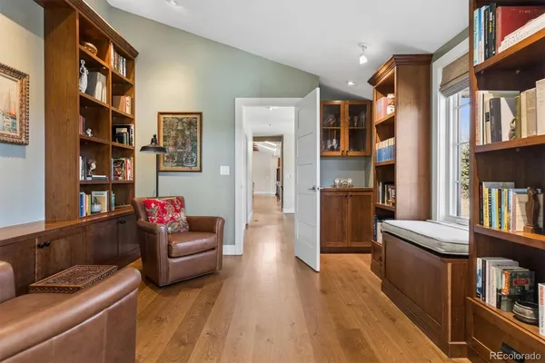 a living room with furniture and a book shelf