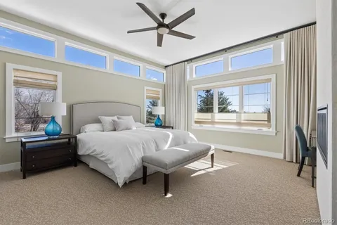 a bedroom with a bed and a large window